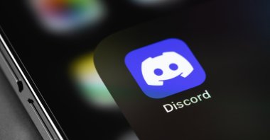 The Discord mobile icon app is seen on a smartphone screen macro.