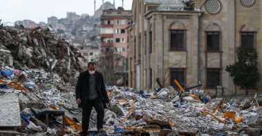 A man walks on debris in the aftermath of a powerful earthquake in Kahramanmaraş, Türkiye, March 24, 2023. (EPA Photo)