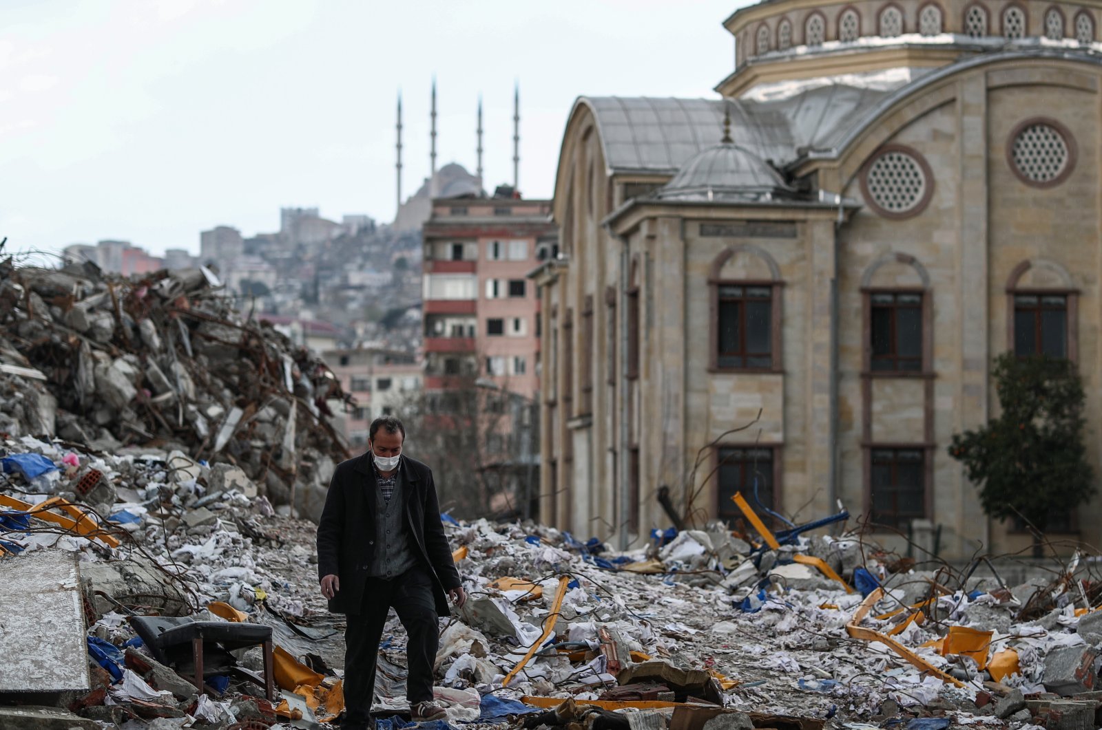 A man walks on debris in the aftermath of a powerful earthquake in Kahramanmaraş, Türkiye, March 24, 2023. (EPA Photo)