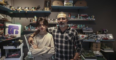 The father Murat Can (R) and his son Ediz Can pose in their diorama production room, Ankara, Türkiye, April 8, 2023. (AA Photo)