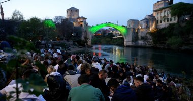More than a thousand people attend an iftar, a fast-breaking dinner, near the historic Mostar Bridge in the city of Mostar, Bosnia-Herzegovina, April 12, 2023. (AA Photo)