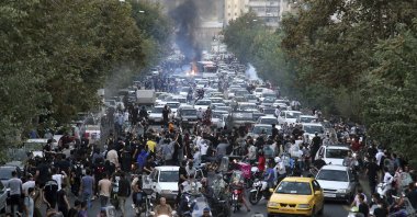 Protesters chant slogans during a protest over the death of a woman who was detained by the morality police, in downtown Tehran, Iran on Sept. 21, 2022. (AP File Photo)