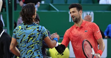 Serbia&#039;s Novak Djokovic (R) and Italy&#039;s Lorenzo Musetti (L) shake hands after their Monte-Carlo ATP Masters Series tournament round of 16 tennis match in Monte Carlo, April 13, 2023. (AFP Photo)