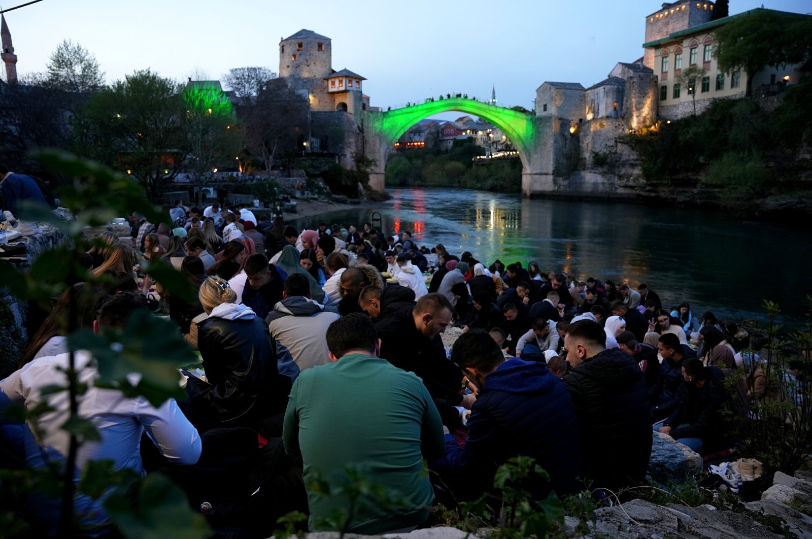 More than a thousand people attend an iftar, a fast-breaking dinner, near the historic Mostar Bridge in the city of Mostar, Bosnia-Herzegovina, April 12, 2023. (AA Photo)