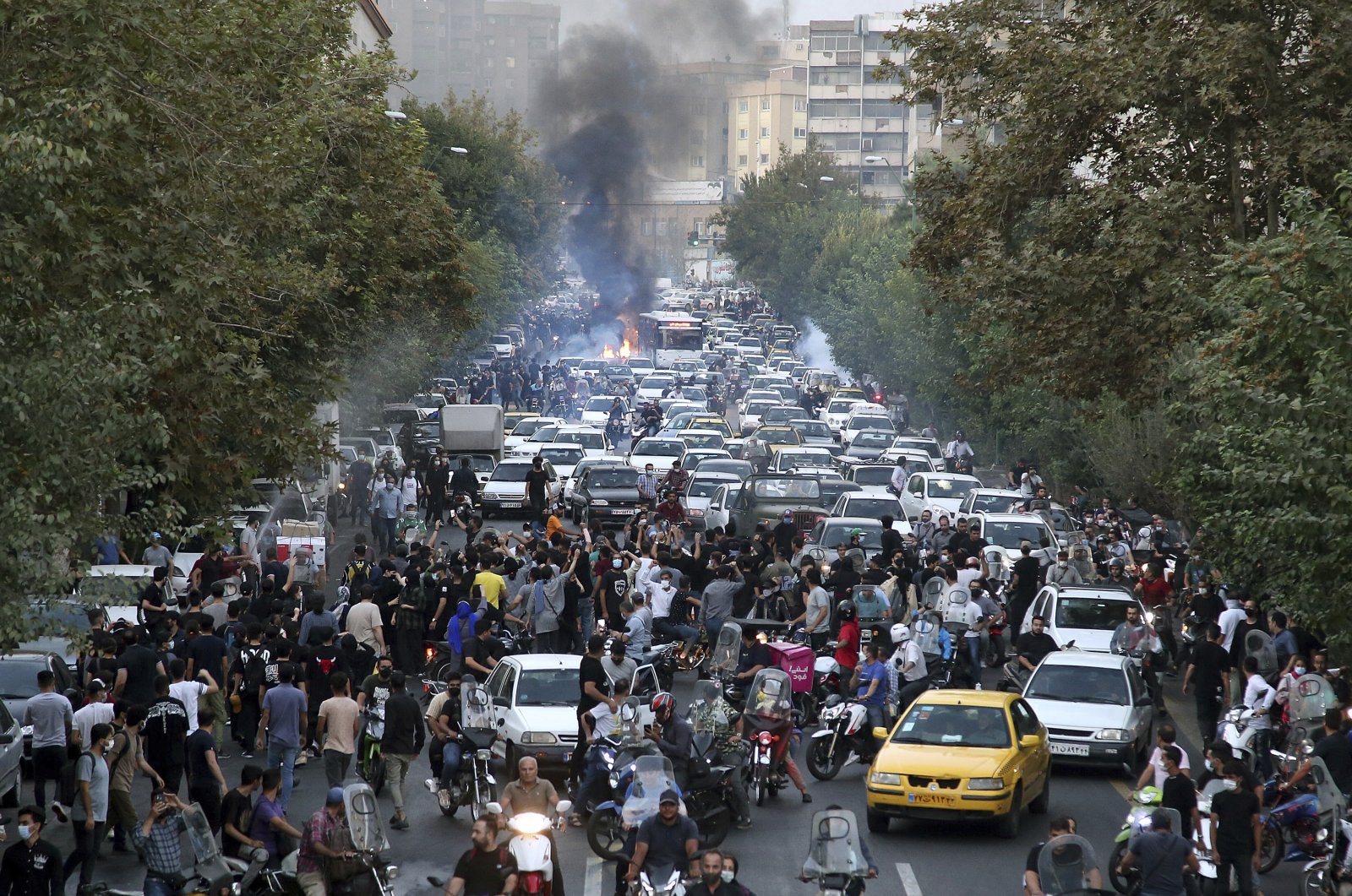 Protesters chant slogans during a protest over the death of a woman who was detained by the morality police, in downtown Tehran, Iran on Sept. 21, 2022. (AP File Photo)