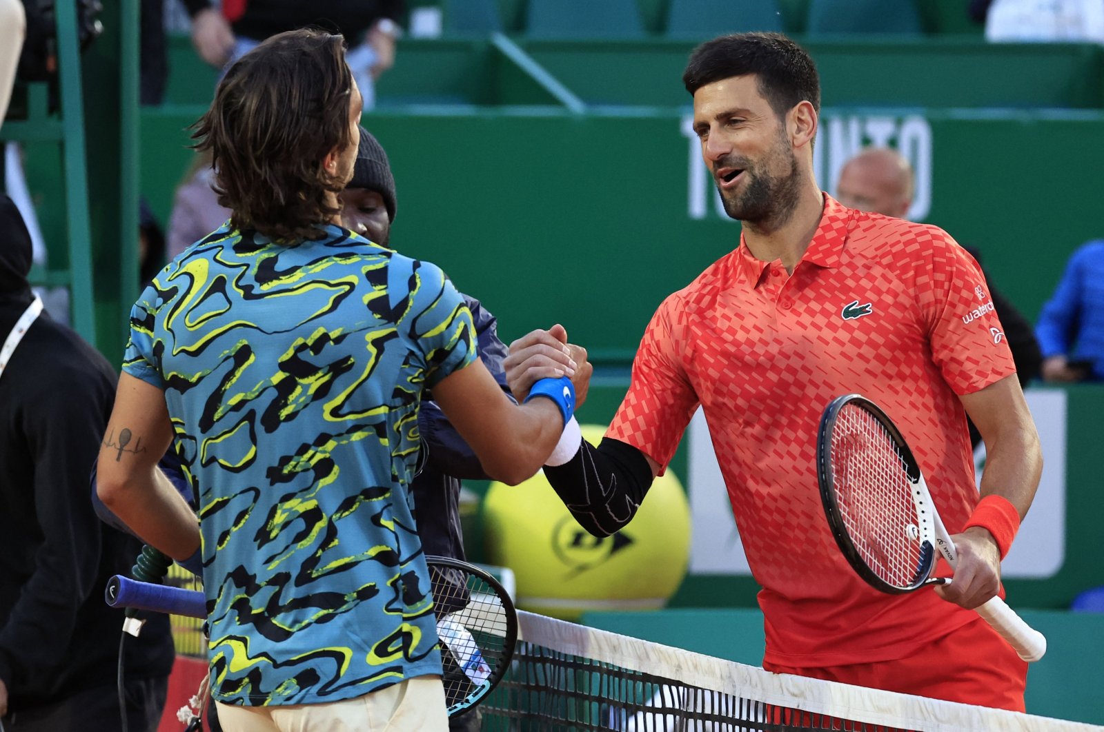 Serbia&#039;s Novak Djokovic (R) and Italy&#039;s Lorenzo Musetti (L) shake hands after their Monte-Carlo ATP Masters Series tournament round of 16 tennis match in Monte Carlo, April 13, 2023. (AFP Photo)