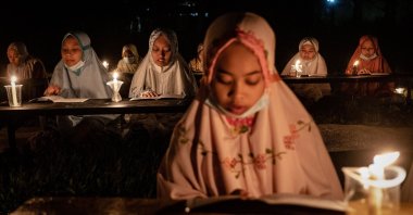 Indonesian Muslims read the Quran by candlelight during Laylat al-Qadr, in Boyolali, Indonesia, May 2, 2021. (Getty Images Photo)