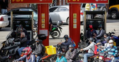 People on motorcycles refill gasoline at a gas station in San Antonio, near Caracas, Venezuela, Sept. 9, 2020. (Reuters Photo)