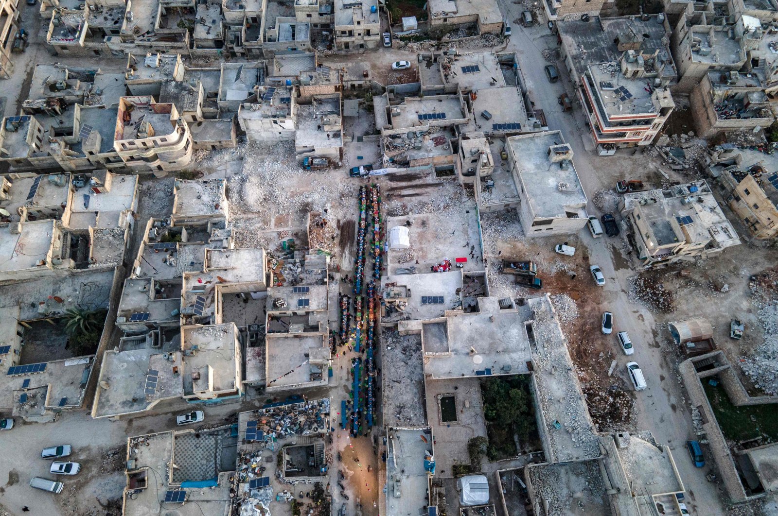 An aerial view of locals, affected by the February 6 earthquake, attending a mass iftar dinner in Atareb town, in the opposition-held western countryside of Aleppo province, March 31, 2023. (AFP Photo)