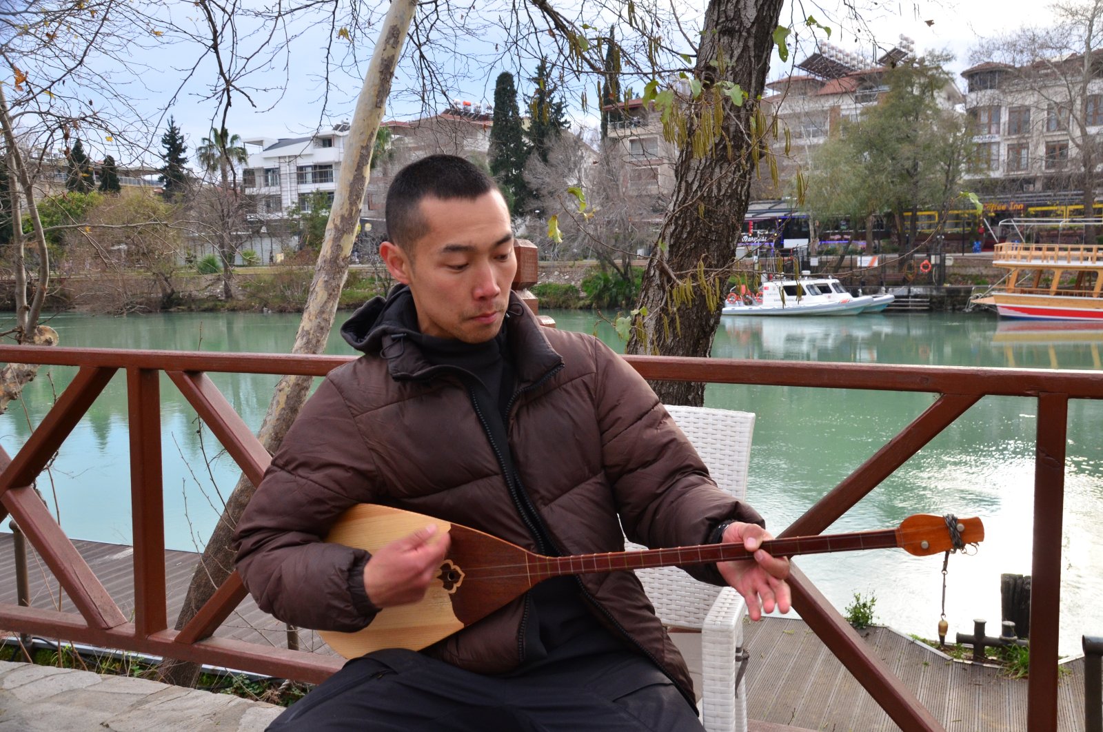 Aman Odun plays a traditional dombra, a long-necked musical string instrument, Antalya, Türkiye, April 15, 2023. (AA Photo)