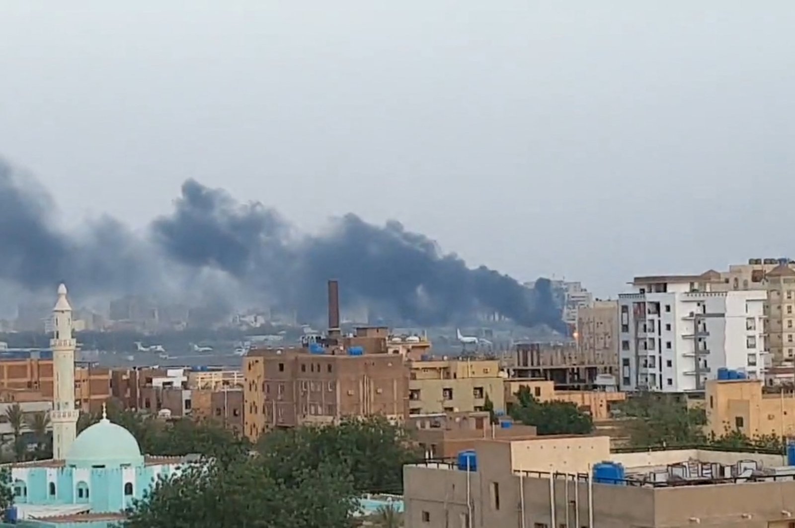 Smoke rises from the tarmac of Khartoum International Airport, in Khartoum, Sudan, April 17, 2023. (Reuters Photo)