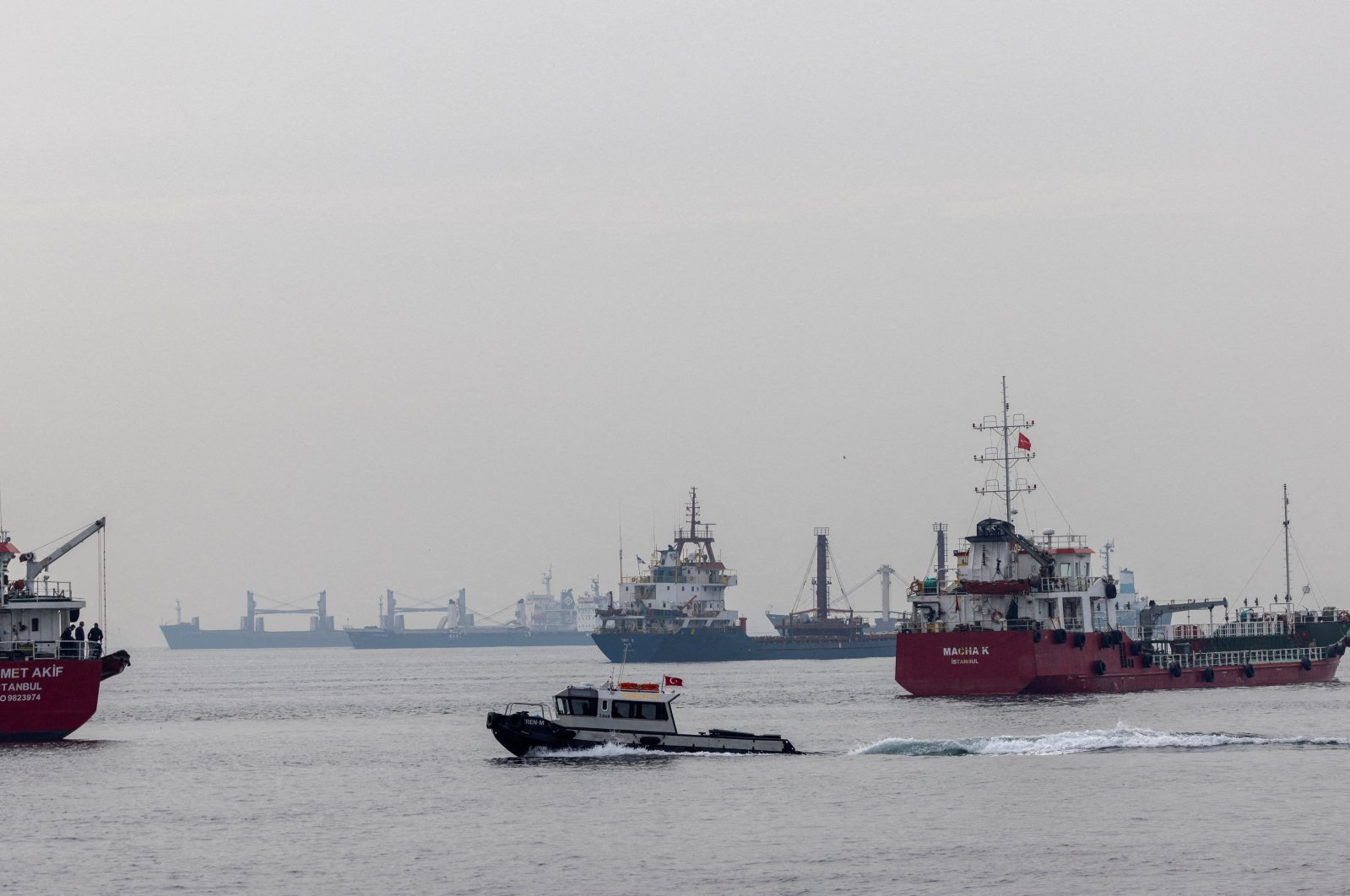 Commercial vessels, including vessels that are part of Black Sea grain deal, wait to pass the Bosporus off the shores of Yenikapı during a misty morning in Istanbul, Türkiye, Oct. 31, 2022. (Reuters Photo)