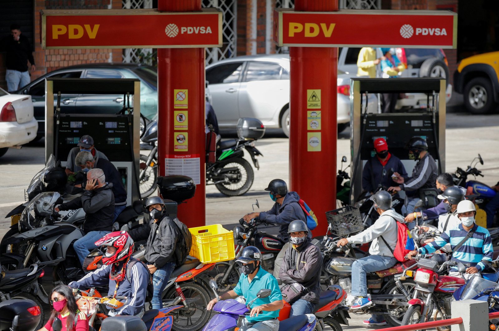 People on motorcycles refill gasoline at a gas station in San Antonio, near Caracas, Venezuela, Sept. 9, 2020. (Reuters Photo)