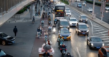 People circulate along the central business district in Beijing, China, April 17, 2023. (EPA Photo)