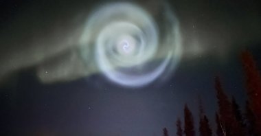 A light baby blue spiral resembling a galaxy appears amid the aurora for a few minutes in the skies near Fairbanks, Alaska, U.S., April 15, 2023. (AP Photo)
