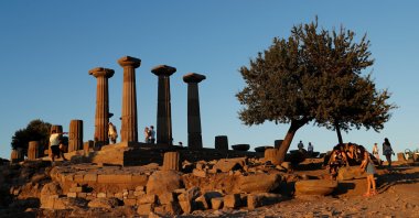 People visit the Temple of Athena in the Aegean tourist hotspot of Assos, or Behramkale, in Çanakkale province, Türkiye, Aug. 14, 2020. (Reuters Photo)