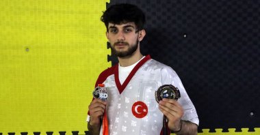 Türkiye kickboxing champion Ferit Özdemir shows his WAKO World Cup and WAKO Europe medals, Istanbul, Türkiye, April 13, 2023. (AA Photo)