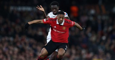 Sevilla&#039;s French defender Tanguy Nianzou (L) vies with Manchester United&#039;s French striker Anthony Martial during the UEFA Europa league quarterfinal, first leg football match at Old Trafford, Manchester, U.K., April 13, 2023. (AFP Photo)