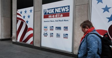 People walk by the News Corporation headquarters, home to Fox News, New York City, U.S., April 18, 2023. (AFP Photo)