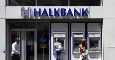 A customer (C) uses an automated teller machine at a branch of Halkbank in Istanbul Aug. 15, 2014. (Reuters File Photo)