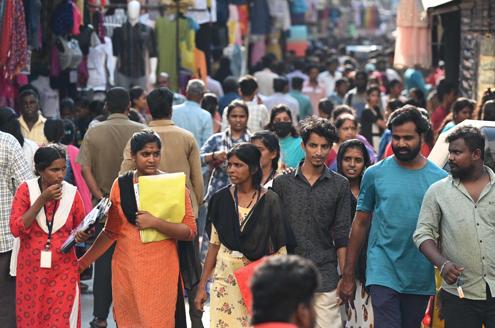 People walk along a market area in Chennai, India, April 19, 2023. (AFP Photo)