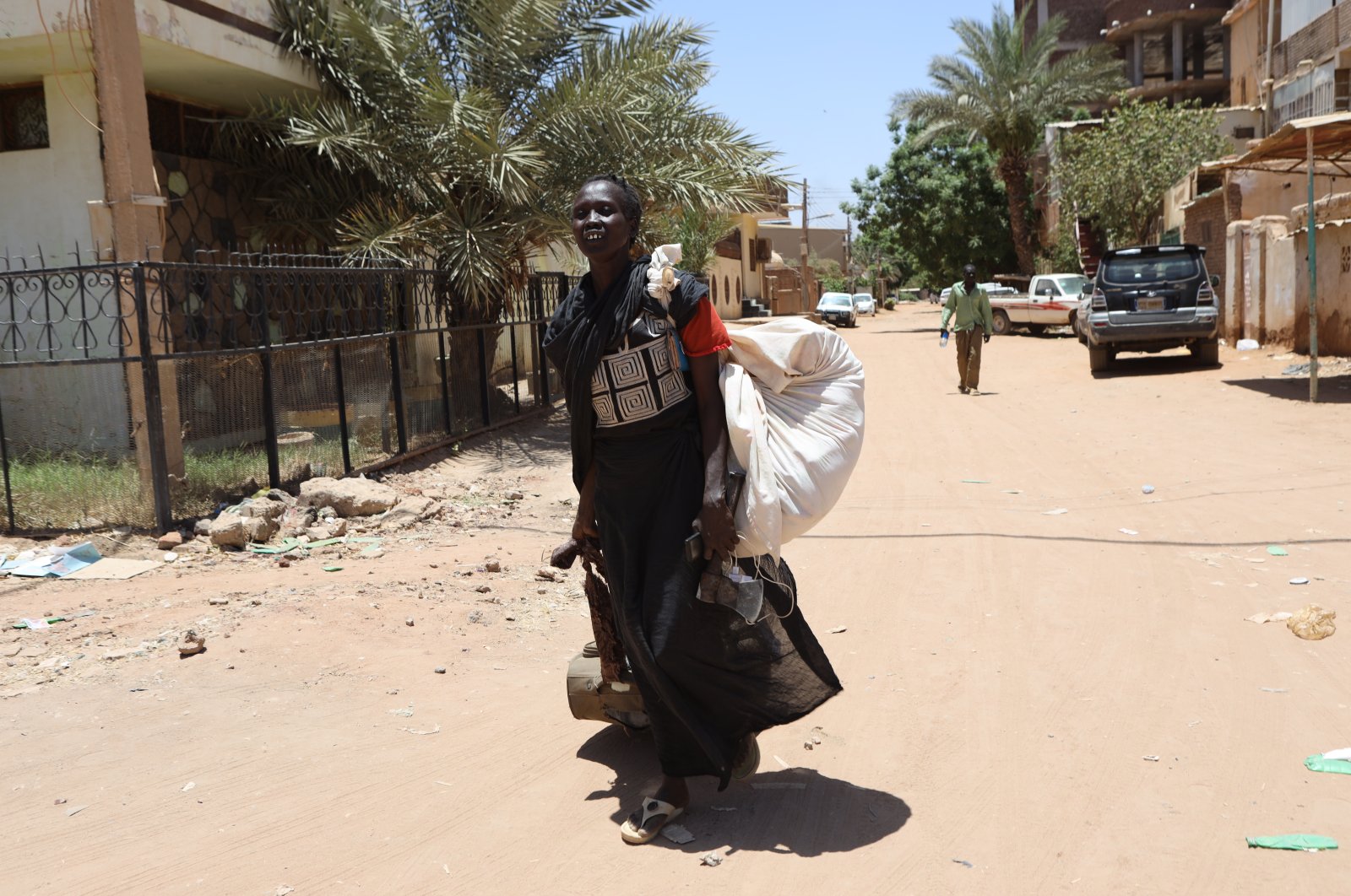 A Sudanese woman carries her belongings on a street in Khartoum, Sudan, April 19, 2023. (EPA Photo)