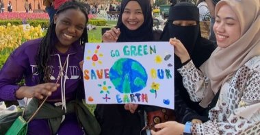 International students pose with posters with messages promoting a green and healthy environment, at the Hagia Sophia Grand Mosque, Istanbul, Türkiye, April 20, 2023. (Photo courtesy of My Fund Action)