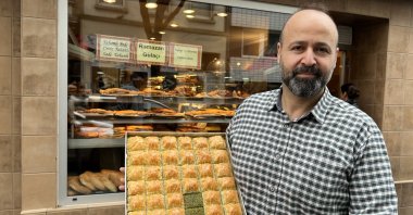 Local baker Ismail Aldağ holds a tray of baklava, Cologne, Germany, April 20, 2023. (AA Photo)