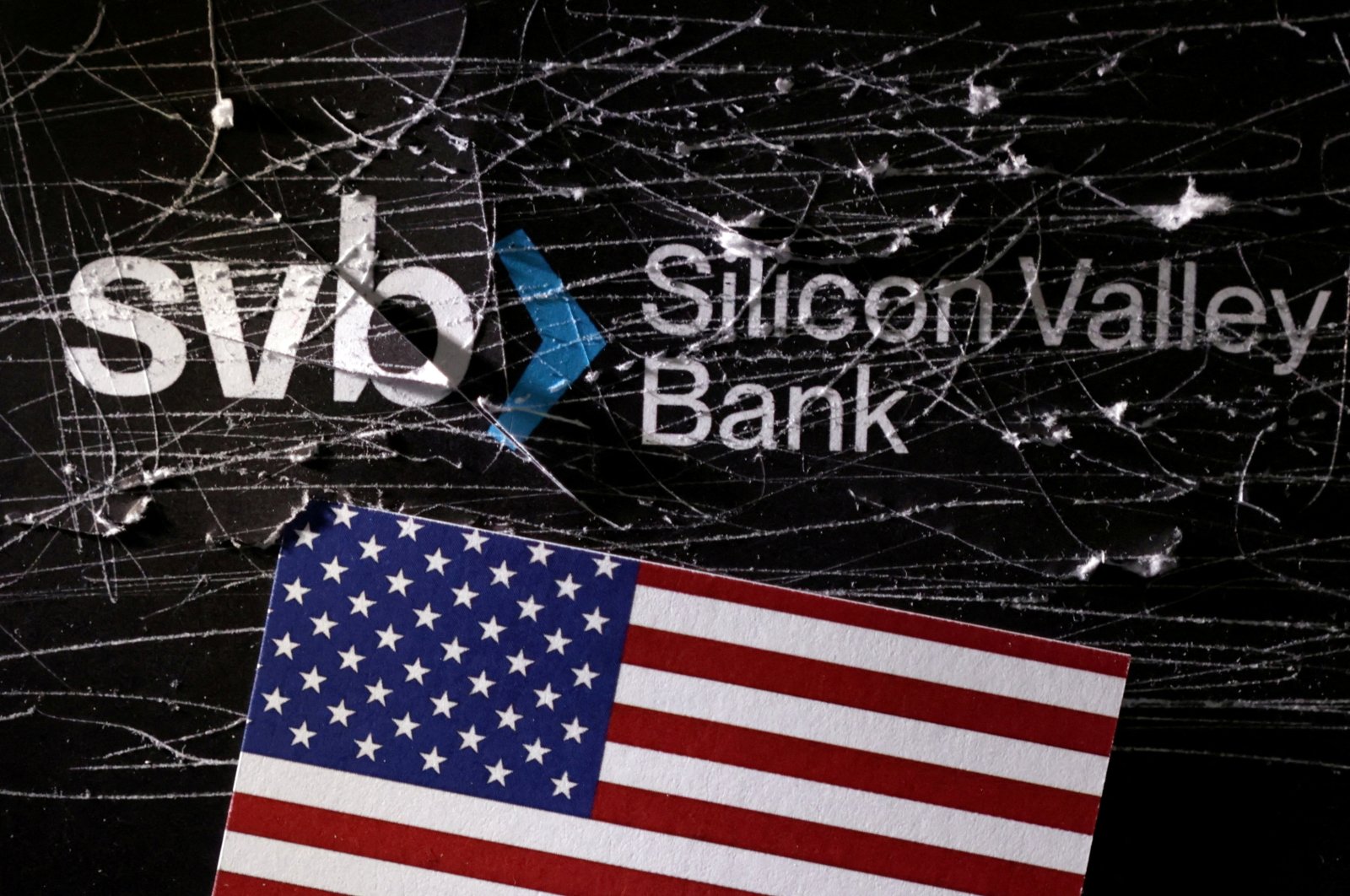 The destroyed Silicon Valley Bank (SVB) logo and the U.S. flag are seen in this illustration taken March 13, 2023. (Reuters Photo)