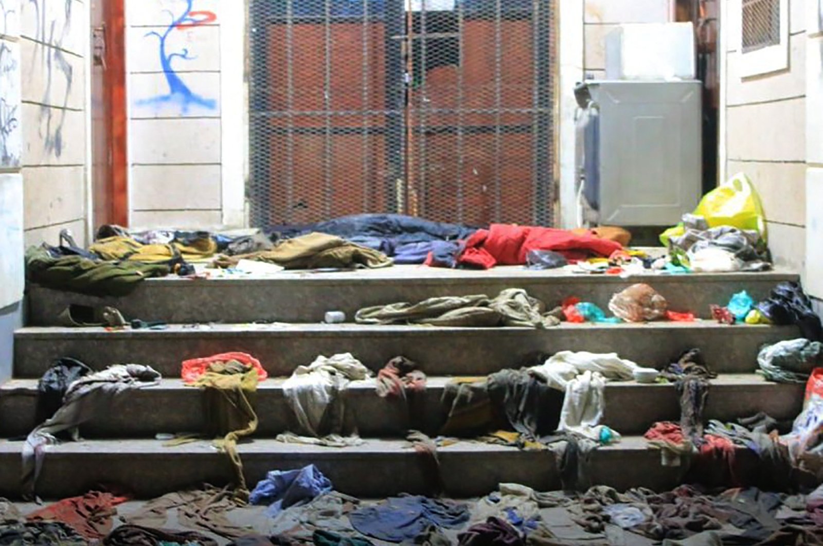 Clothes strewn at the scene of a stampede on the steps of a charity distribution center in Sanaa, Yemen, April 20, 2023. (AFP Photo)