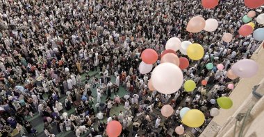 Balloons are distributed for free after Eid al-Fitr prayers, marking the end of the Muslim holy fasting month of Ramadan outside al-Seddik Mosque in Cairo, Egypt, April 21, 2023. (AP Photo)