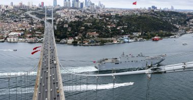 The TCG Anadolu, Türkiye’s first amphibious assault ship, passes under the July 15 Martyrs Bridge as it sails in the Bosporus in Istanbul, Türkiye, April 23, 2023. (AA Photo)