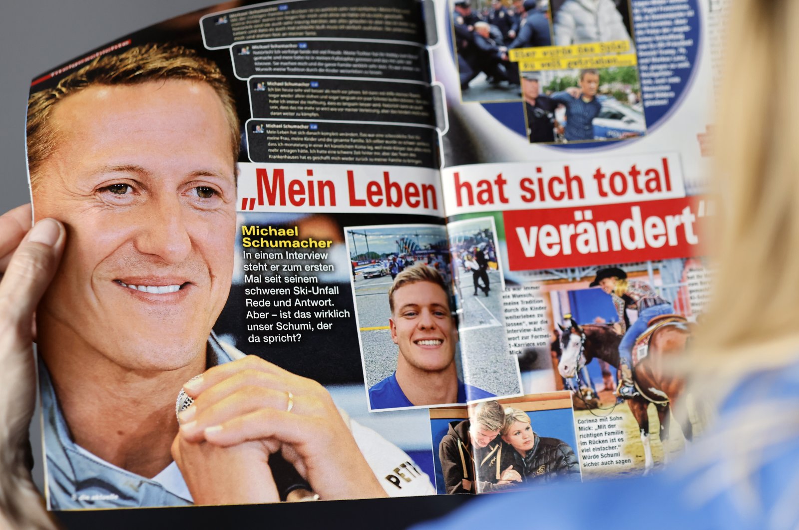 A woman reads the edition of German weekly magazine Die Aktuelle with the cover announcing a fake interview with Michael Schumacher, Berlin, Germany, April 20, 2023. (EPA Photo)
