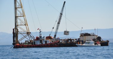 A boat places concrete blocks as part of an artificial reef project off the coast of Türkiye, April 23, 2023. (AA Photo)