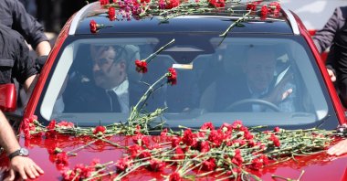 President Recep Tayyip Erdoğan drives Türkiye's domestically developed vehicle Togg as he is greeted by a crowd in Bursa province, northwestern Türkiye, April 24, 2023. (IHA Photo)