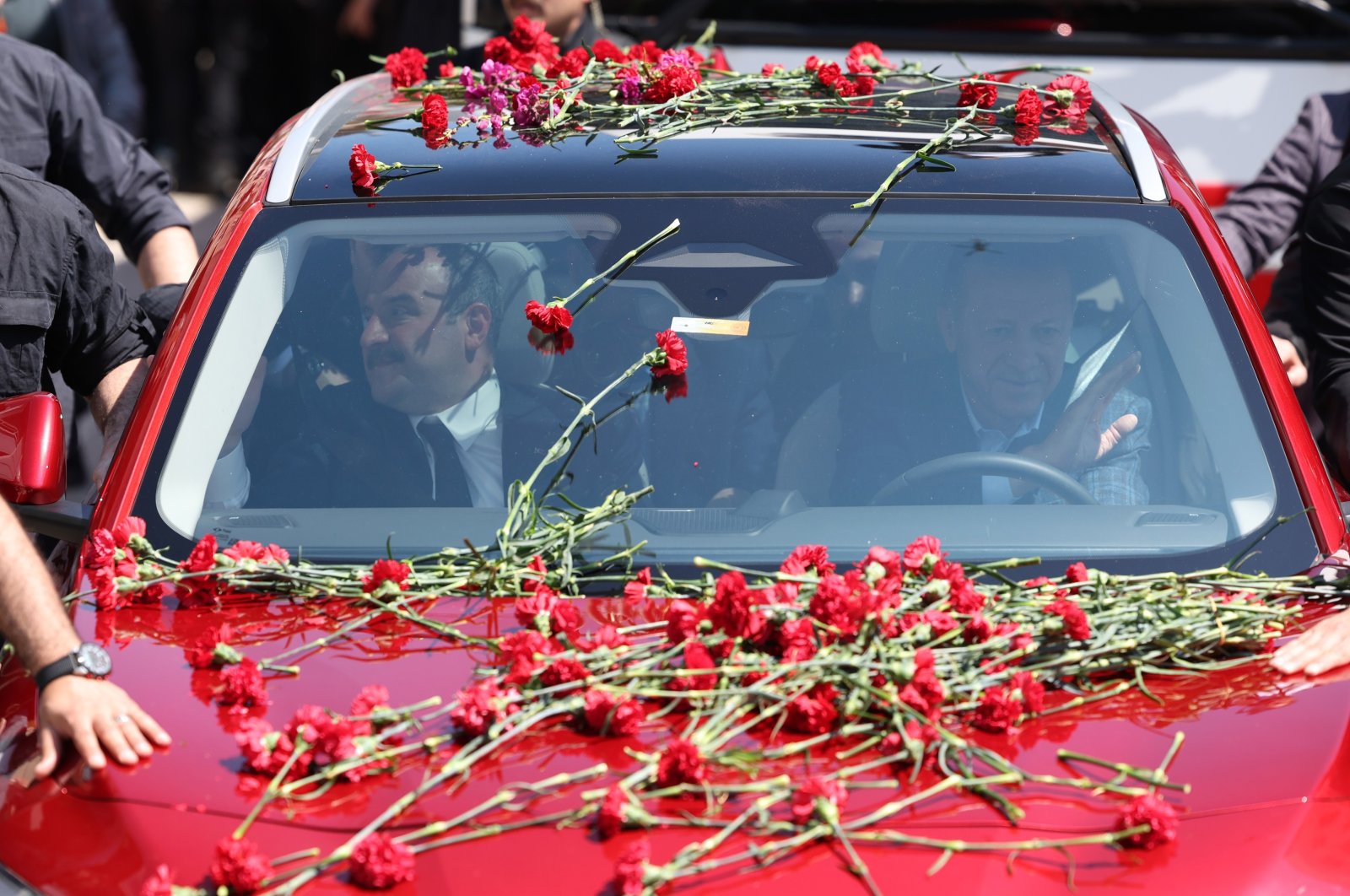 President Recep Tayyip Erdoğan drives Türkiye&#039;s domestically developed vehicle Togg as he is greeted by a crowd in Bursa province, northwestern Türkiye, April 24, 2023. (IHA Photo)