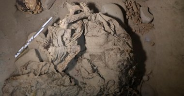 Skeletal remains and parts of the funerary bundle of a mummy found by Peruvian archaeologists are seen in the ruins of Cajarmarquilla, in the outskirts of Lima, Peru, April 24, 2023. (Reuters Photo)