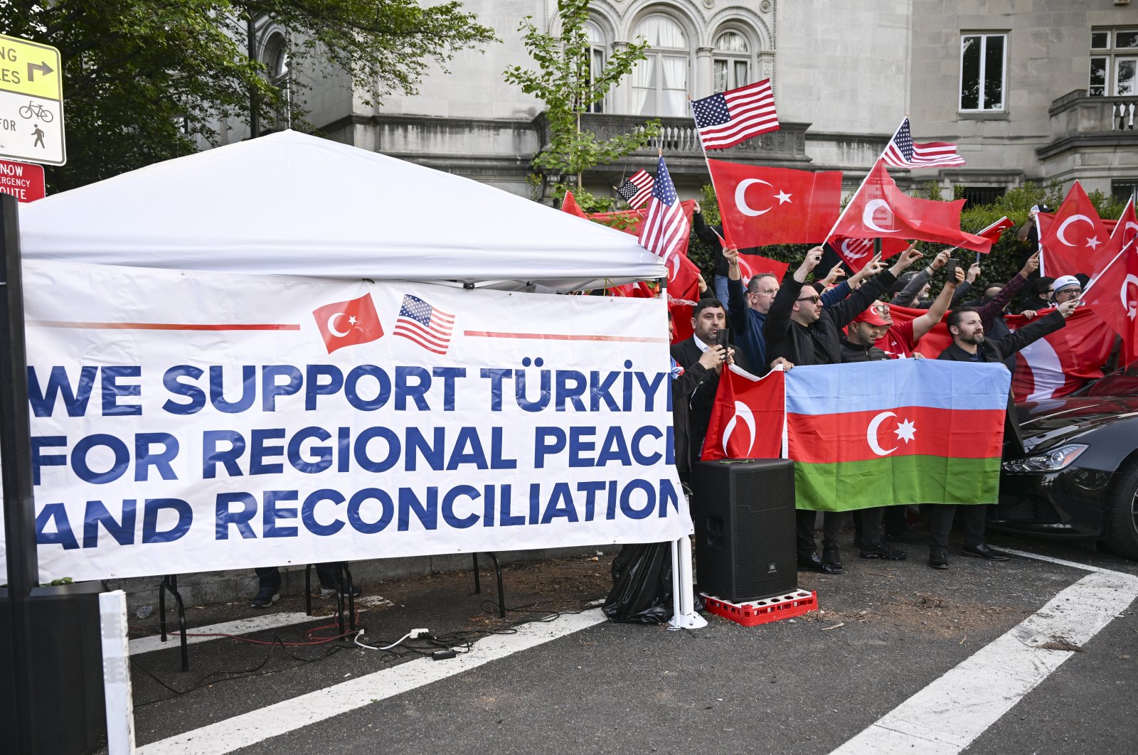 Turks and Azerbaijanis wave Turkish, Azerbaijani and American flags and banners as they counter-protest a group of Armenians that condemned the 1915 events in Ottoman Türkiye, in front of the Turkish Embassy in Washington, U.S., April 24, 2023. (AA Photo)
