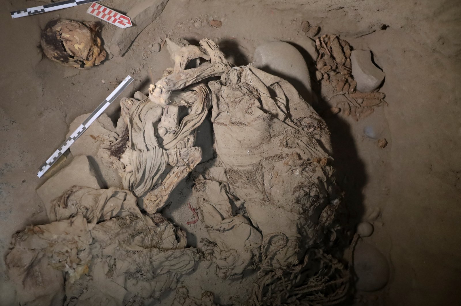 Skeletal remains and parts of the funerary bundle of a mummy found by Peruvian archaeologists are seen in the ruins of Cajarmarquilla, in the outskirts of Lima, Peru, April 24, 2023. (Reuters Photo)