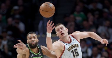 Minnesota Timberwolves' Rudy Gobert (L) fights for a lose ball against Denver Nuggets' Nikola Jokic (R) in the second quarter during Round 1 Game 5 of the NBA Playoffs at Ball Arena, Denver, U.S., April 25, 2023. (AFP Photo)