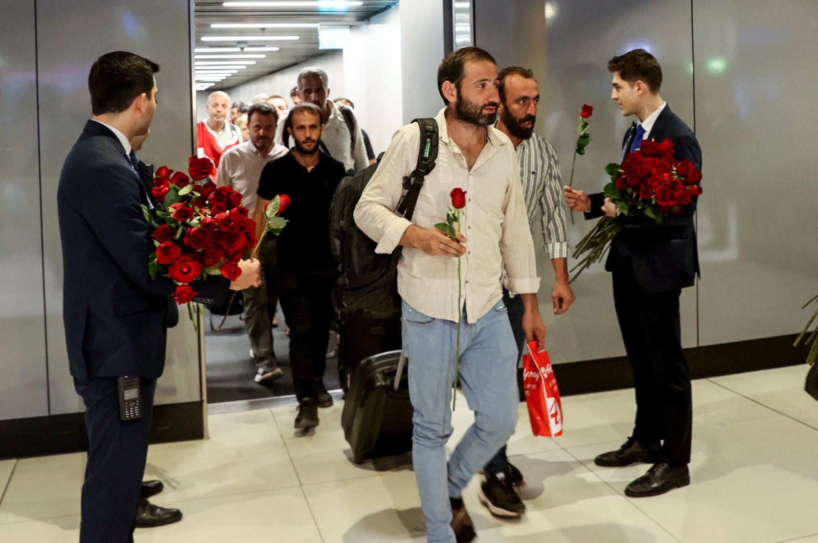 Turkish civilians evacuated from Sudan are greeted with flowers by staff at Istanbul Airport, Türkiye, April 26, 2023. (AA Photo)