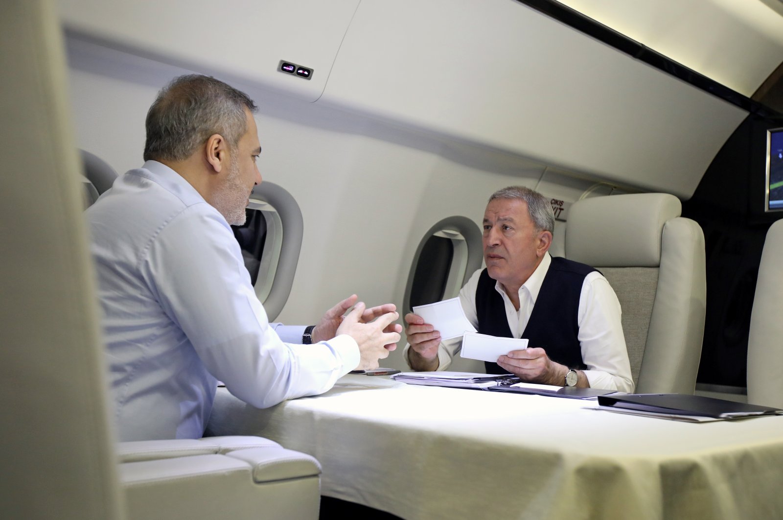 Defense Minister Hulusi Akar (R) is seen with Intelligence chief Hakan Fidan (L) on the plane during his visit to Moscow, Russia, April 25, 2023 (AA Photo)
