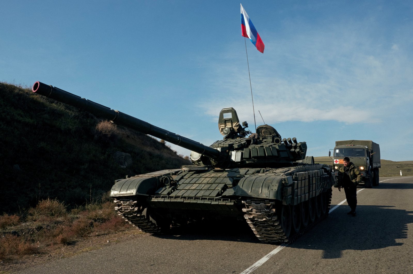 A service member of the Russian peacekeeping troops stands next to a tank near the border with Armenia, following the signing of a deal to end the military conflict between Azerbaijan and ethnic Armenian forces, in the region of Karabakh, Nov. 10, 2020. (Reuters Photo)