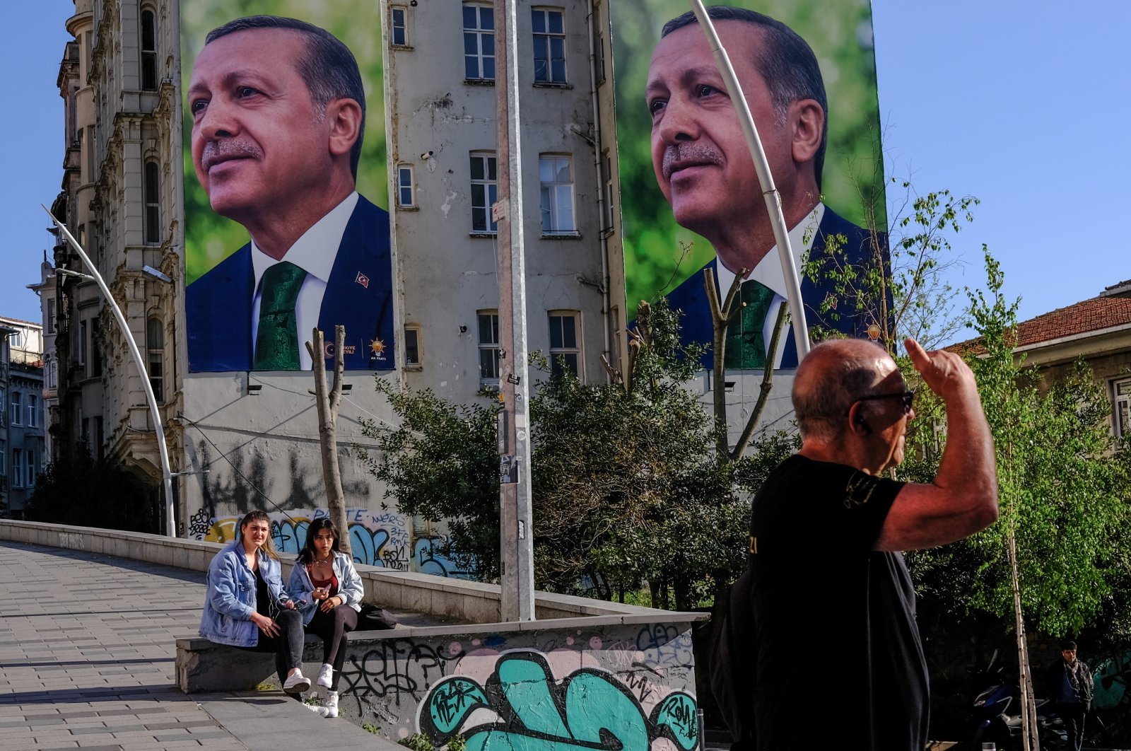 Young girls sit in front of the pictures of President Recep Tayyip Erdoğan, in Istanbul, Türkiye, April 24, 2023. (EPA Photo)