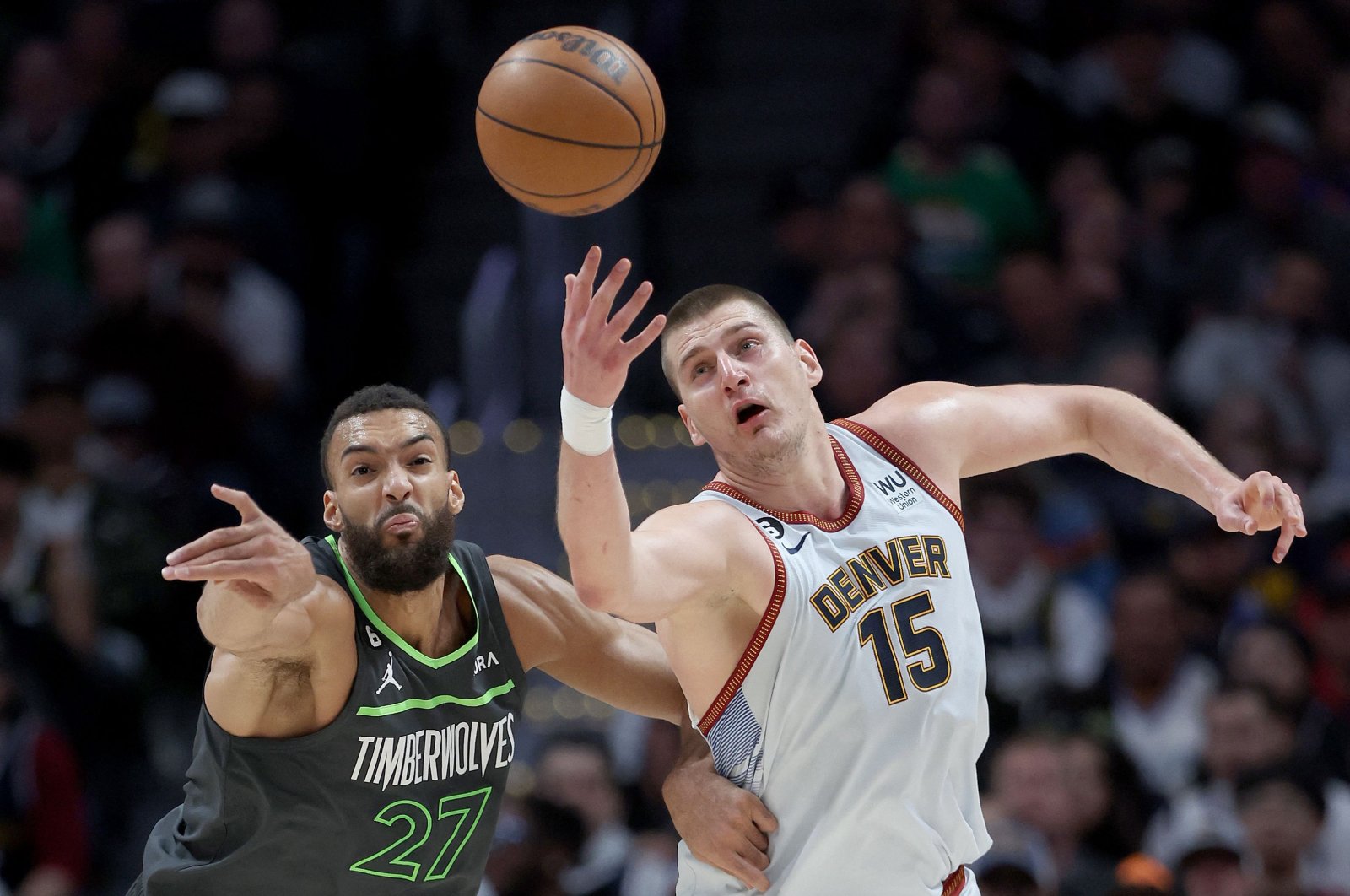 Minnesota Timberwolves&#039; Rudy Gobert (L) fights for a lose ball against Denver Nuggets&#039; Nikola Jokic (R) in the second quarter during Round 1 Game 5 of the NBA Playoffs at Ball Arena, Denver, U.S., April 25, 2023. (AFP Photo)