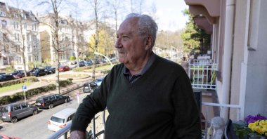 Sener Sargut stands on the balcony of his home in Frankfurt, western Germany, March 27, 2023. (AFP Photo)