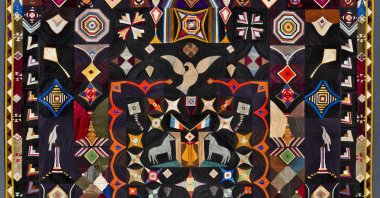 The photo shows the Original Design Quilt made by Corning, New York tailor Carl Klewicke around 1907. The piece is made of vivid bits of silk, faille, taffeta and satin depicting stars, kites and doves. (AP Photo)