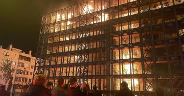 People watch as fire covers Folkart condominium in Izmir, Thursday, April 27, 2023. (AA Photo)