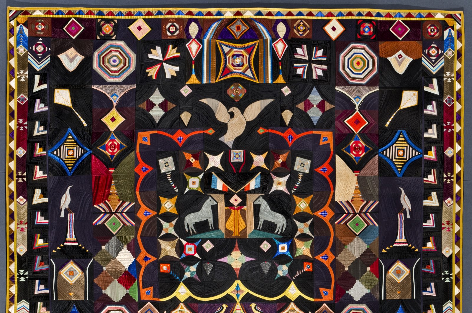 The photo shows the Original Design Quilt made by Corning, New York tailor Carl Klewicke around 1907. The piece is made of vivid bits of silk, faille, taffeta and satin depicting stars, kites and doves. (AP Photo)