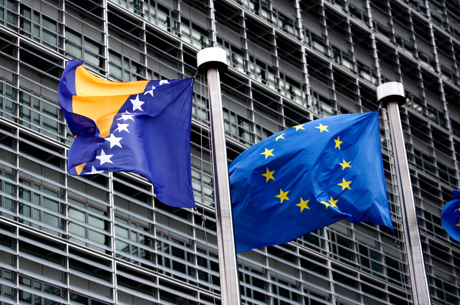 Flags of the EU and Bosnia and Herzegovina wave outside of the European Commission, Brussels, Belgium. March 4, 2019. (Shutterstock Photo)